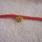 Small gold heart on red square