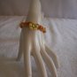 Yellow flower with wood beads on light orange square
