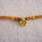 Yellow flower with wood beads on light orange square