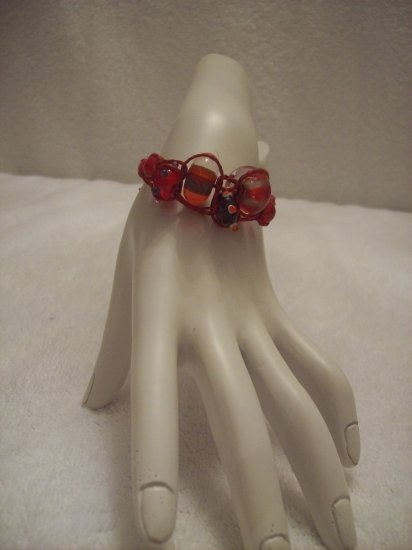 Abstract glass beads on burgundy square
