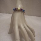 Gold star with purple and blue beads (4) on tan braid