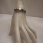 Gold star with purple and blue beads (4) on tan braid