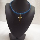 Small gold cross on royal blue square