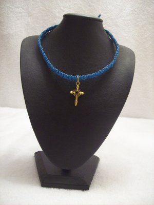Small gold cross on royal blue square