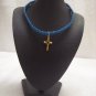 Small gold cross on royal blue square