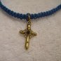 Small gold cross on royal blue square
