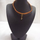 Gold heart key on orange square