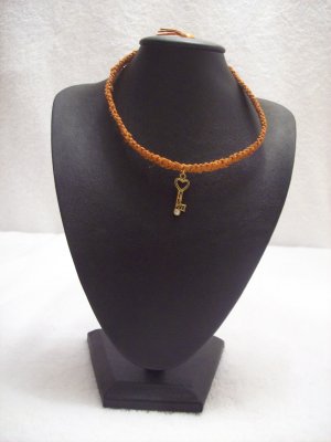 Gold heart key on orange square