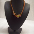Abstract glass beads on orange square