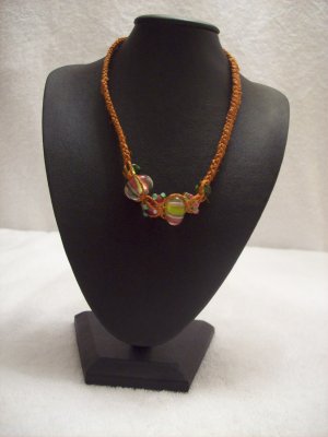 Abstract glass beads on orange square
