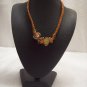 Abstract glass beads on orange square
