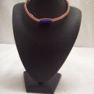 Blue beads (6, strung on) on red and white square