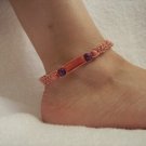 Pink cyllinder with wooden beads on pink square