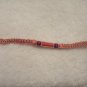 Pink cyllinder with wooden beads on pink square
