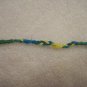Blue, green, and yellow braided wrap