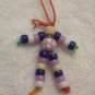 Flower bead (purple), tan, dark blue, purple, white