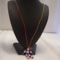 Flower bead (purple), tan, dark blue, purple, white