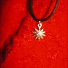 SILVER-TONED SUN CHARM ON CORD