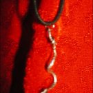 SILVER-TONED SNAKE CHARM ON CORD