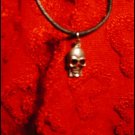 SILVER-TONED SKULL CHARM ON CORD