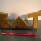 PRIMITIVE "EAT" WOOD WORD SIGN.