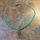 Silvertone And Turquoise Colored Bead Religious Pendant Necklace