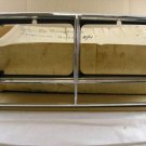 1982 1986 Pontiac Bonneville head lamp NOS bezel LH