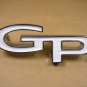 1967 Pontiac Grand Prix headlamp door emblem new