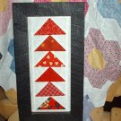 Red flying geese quilt framed stitchery