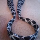 White headband with black poka dots and sqaures