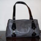 Gray leather with black patent leather details and buckles