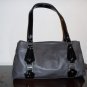 Gray leather with black patent leather details and buckles