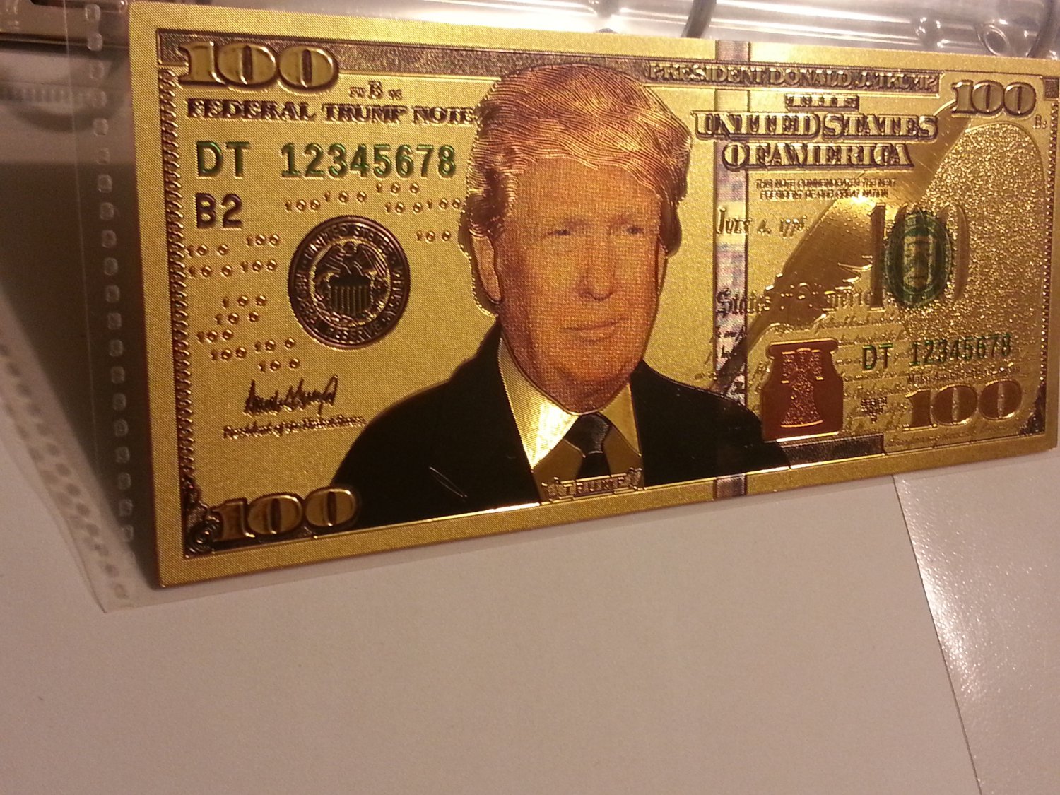 Trump 100 tariff dollar