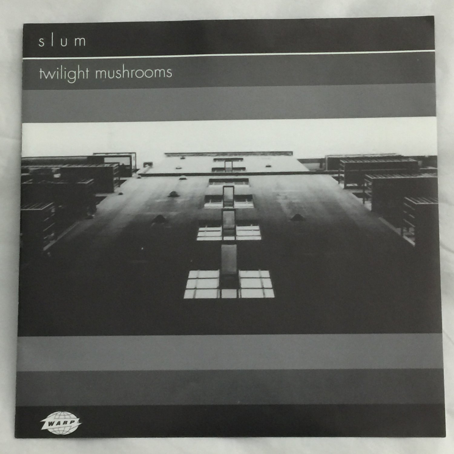7WAP117 - Slum - Twilight Mushrooms (7") WARP RECORDS