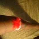 Red garter with feather and heart