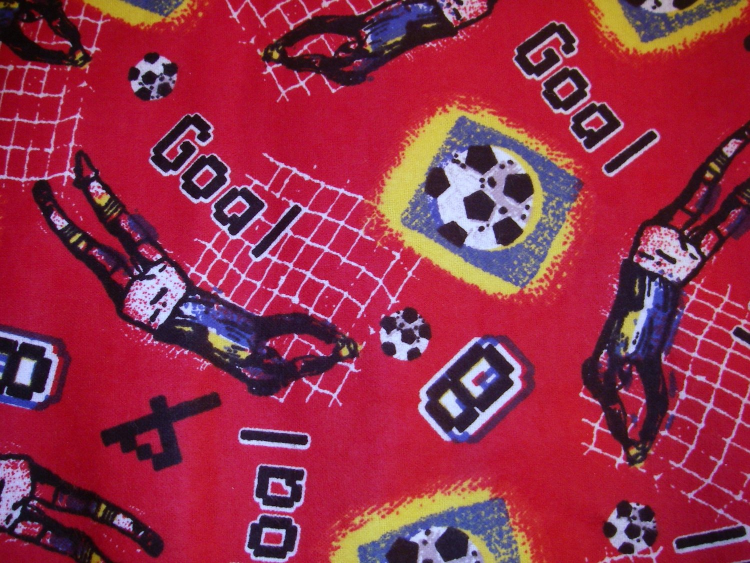 1.33 yard - Red flannel fabric with Soccer theme - Goal, players and balls all over