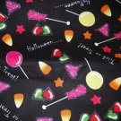 1.33 yards - Halloween candy with sparkles on black fabric - Pink, purple, red, green, yellow