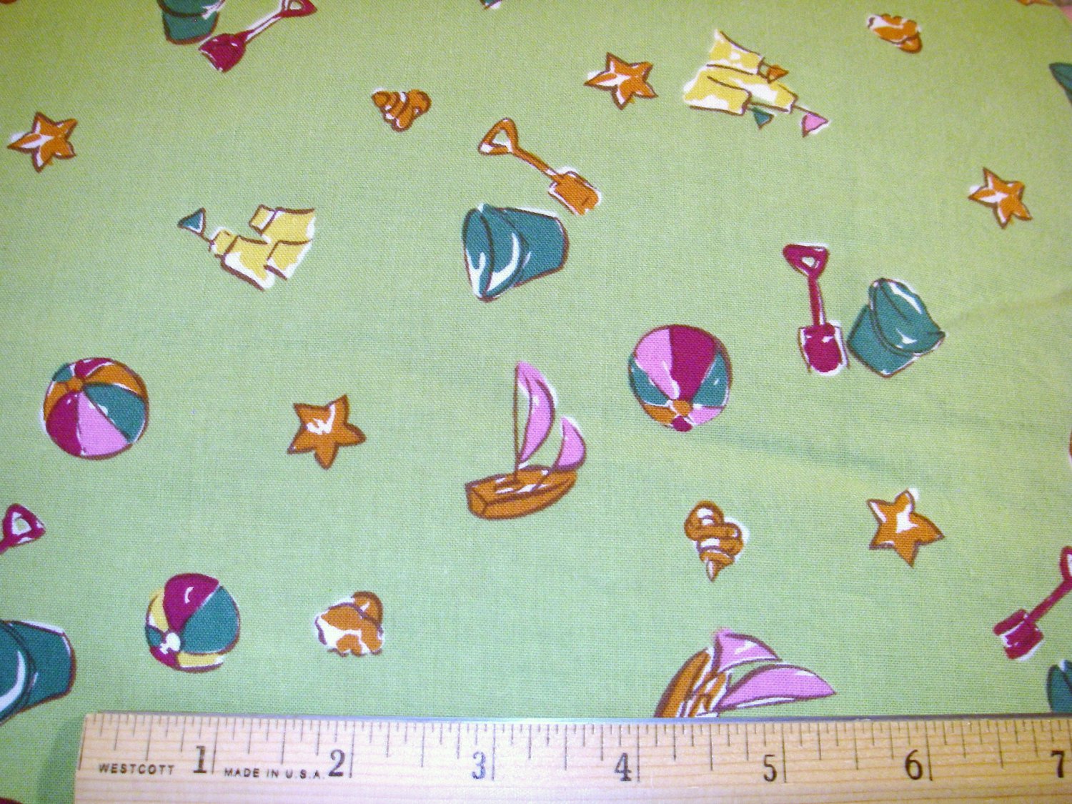 1.875 yards - Beach items on medium green fabric - Pails, sand castles, beach balls, boats