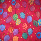 2.33 yards - Bright colorful balloons all over red flannel fabric