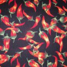 1 yard - Black fabric with red chili peppers