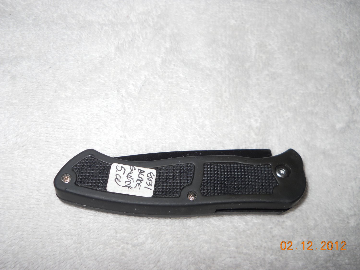 Switchblade style knife with hidden button and lock