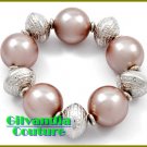 Stretch costume bracelet featuring silver tint and chocolate brown acrylic pearls.