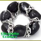 Costume bracelet flaunts the latest look in black chunky stones with fine metalwork.
