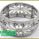 A stretch boutique bracelet that flaunts silvertone finish, rhinestones with filigree theme.