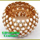 Designer inspired bracelet flaunts a gold finish and Kar•rat!® acrylic white stones.