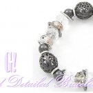 Fashion bracelet that boast glass crystals, filigree metalwork, with dark rhodiumode finish.