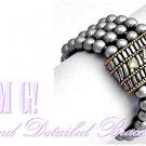 A sophisticated designer inspired bracelet features a combination of luxury and style.