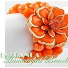 JONFRANCA fashion bracelet featuring orange Paramount® acrylic flowers and pearls.