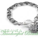 Blizzard ice stones with bright heart charm and metalwork.  JONFRANCA fashion bracelet.