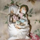 Porcelain Figurine with Vase trimmed in Liquid Gold